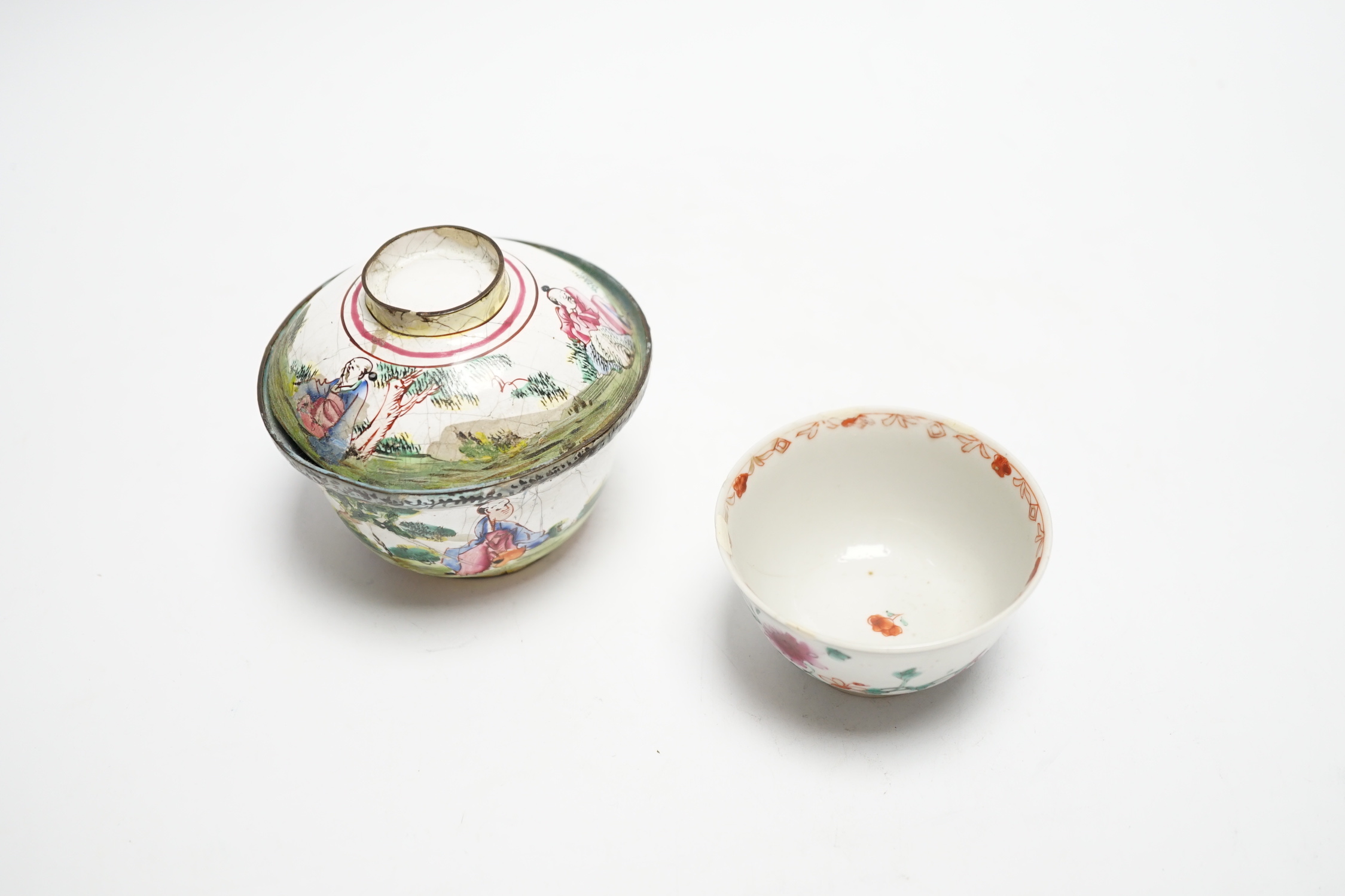 A Chinese Canton enamel tea bowl and cover, and a porcelain tea bowl, largest 8cm high